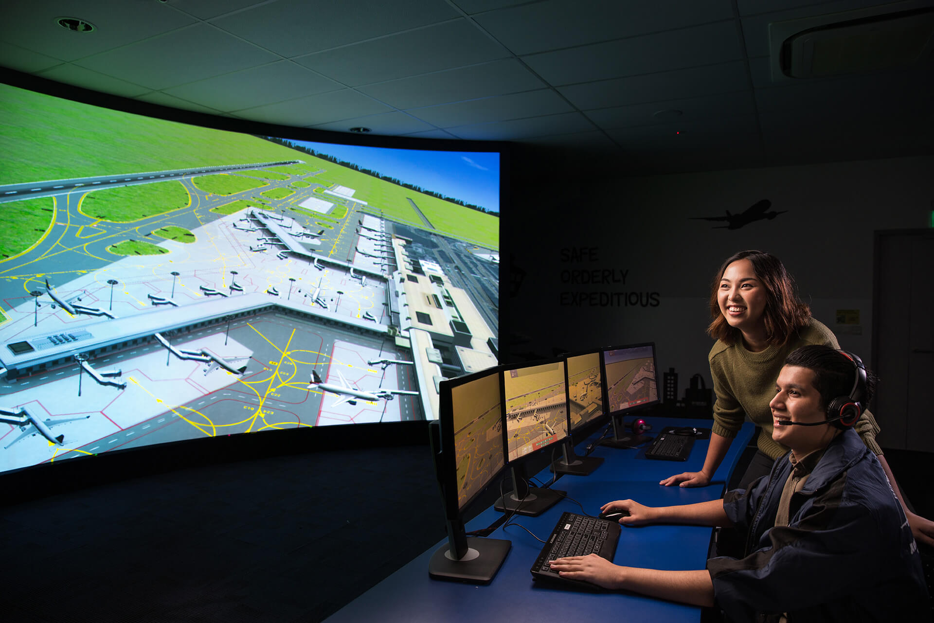 Two students learning about airport operations in a virtual aerodrome