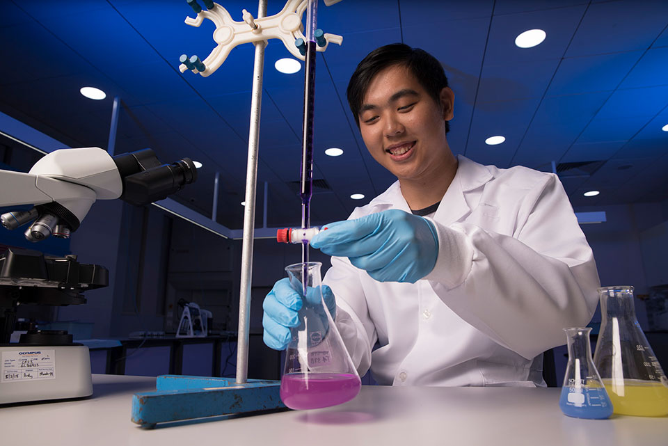 A male student scientist in a science lab