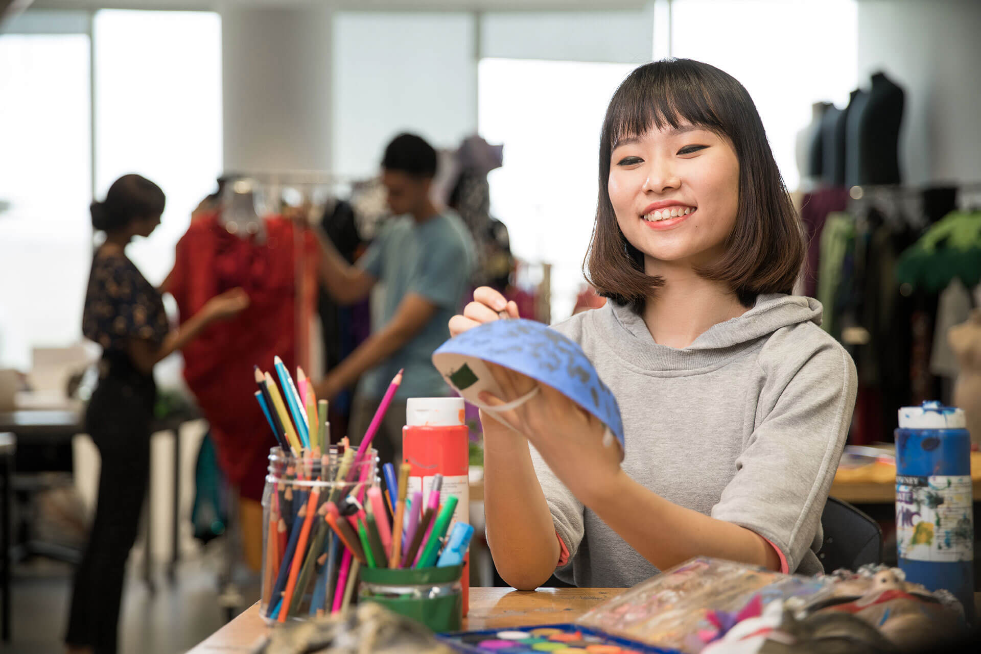 A RP School of Technology for the Arts student painting a theatre mask