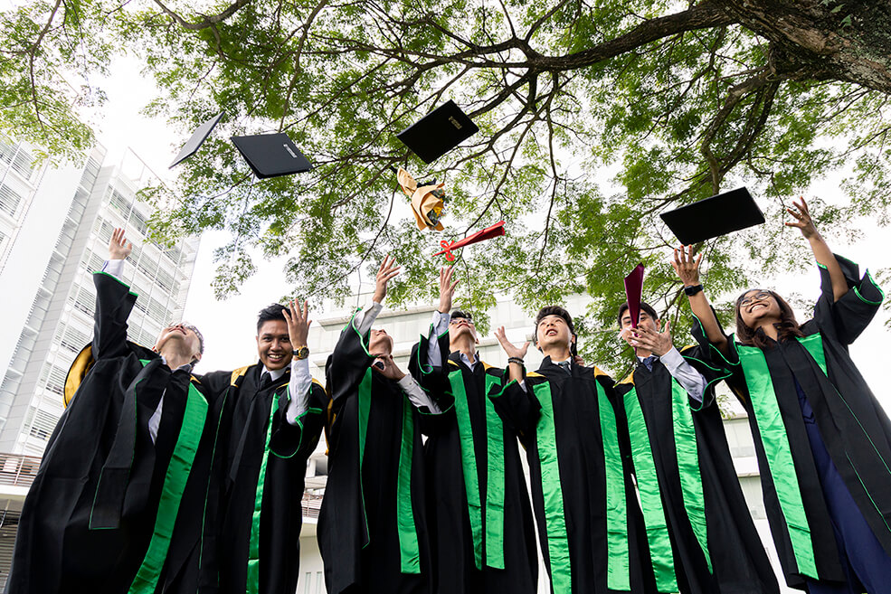 Graduates tossing their diplomas in the bear