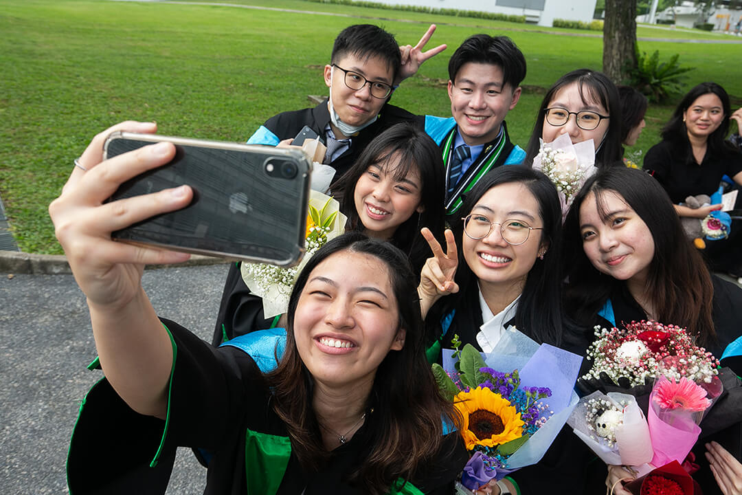 Graduates taking a wefie together with her friends