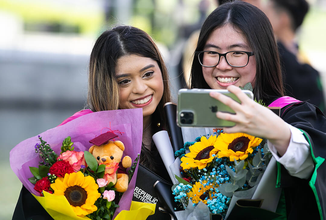 Two graduates taking a selfie