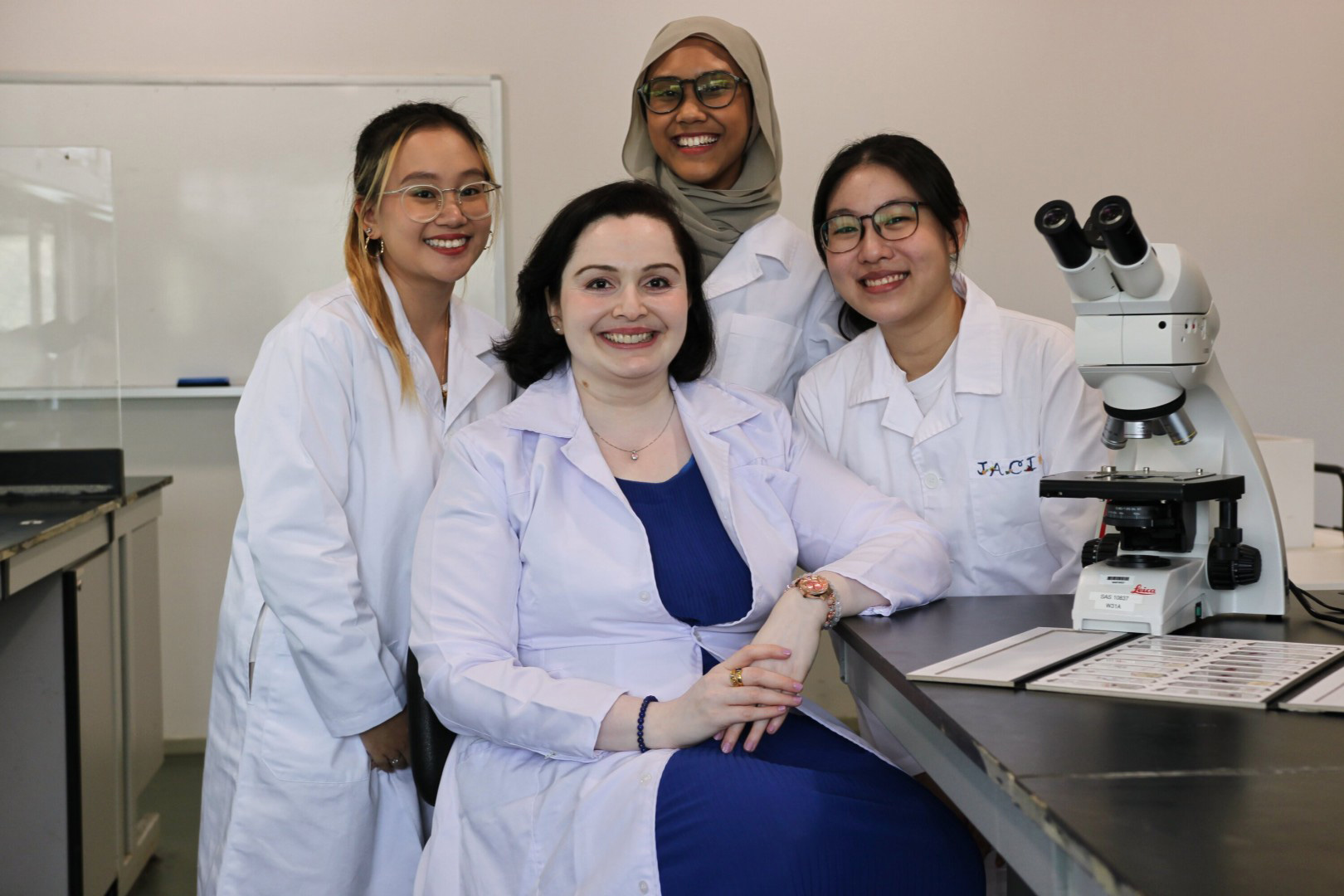 Malini and her students in a lab