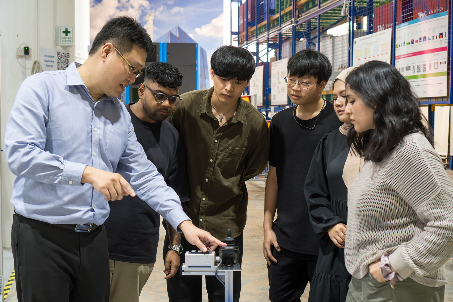 President's Award for Teachers Finalist, Vincent Lim, demonstrating a supply chain equipment to his students