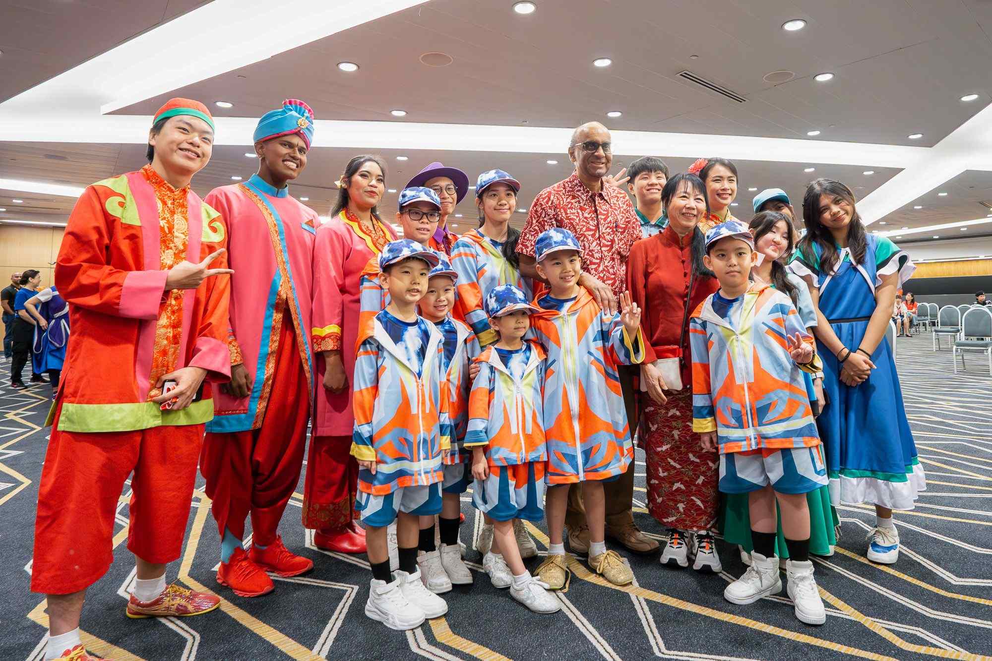 President Tharman and Ms Jane Ittogi engaging with children and youths in vibrant cultural costumes