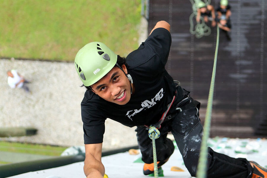 Participant is all smiles while attempting the Sport Climbing Wall