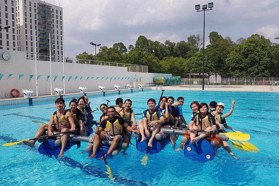 Participants paddling on the improvised raft during a teambuilding programme.