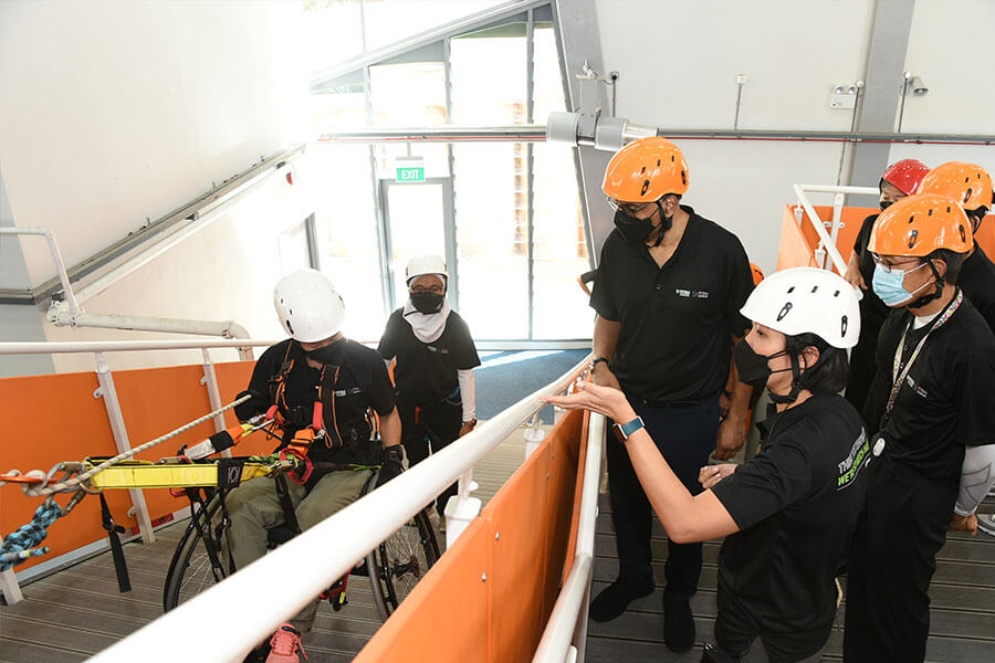 Senior Minister Tharman Shanmugaratnam at the opening of the Xperiential Learning Centre (XLC) on 6 January 2022. SM Tharman was observing a wheelchair participant descending the adventure ramp.