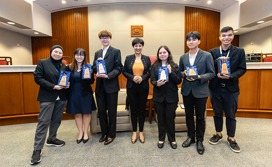 Rosales Sophia Marie Tadeo and fellow winners with Ms Indranee Rajah, Minister, Prime Minister's Office, Second Minister for Finance and Second Minister for National Development (Photo by: REACH, Ministry of Communications and Information)