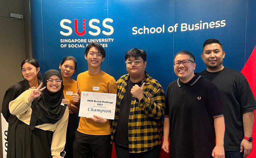 SUSS Brand Challenge 2023 champions with their mentors Mr Caleb Ng and Mr Firdaus Ghani.